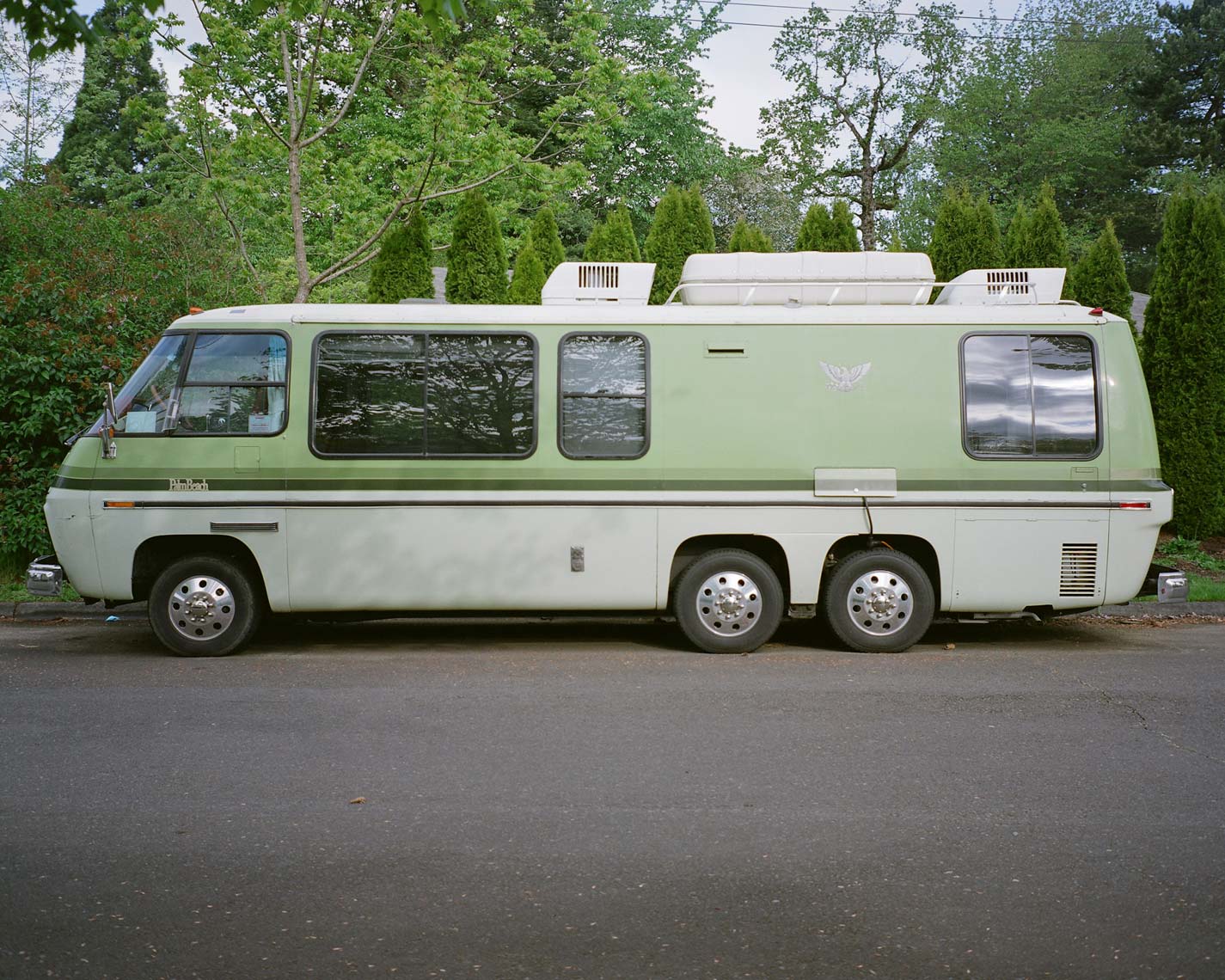 green GMC motorhome on an oregon street