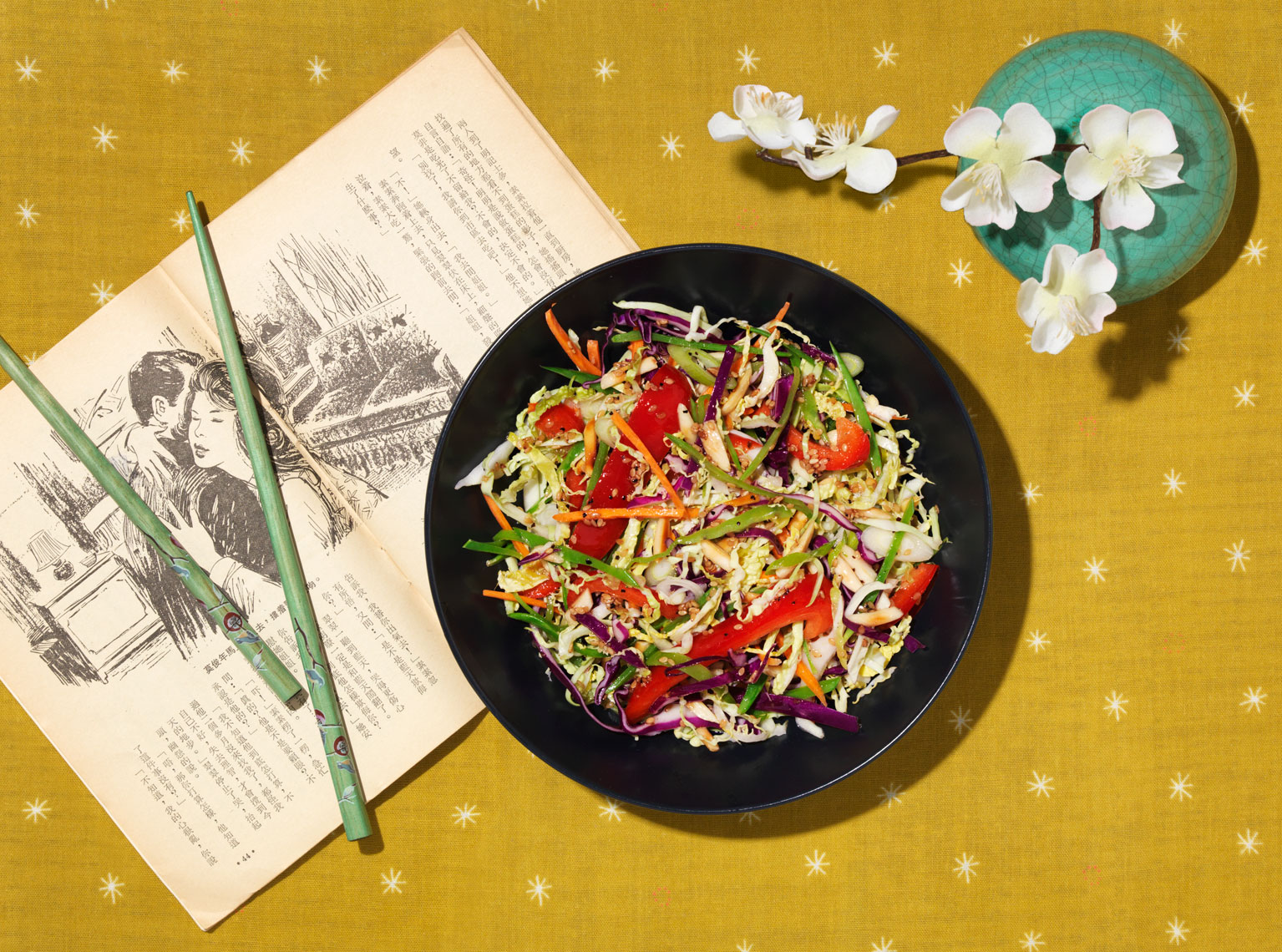 asian slaw with red peppers on mustard yellow placemat 
