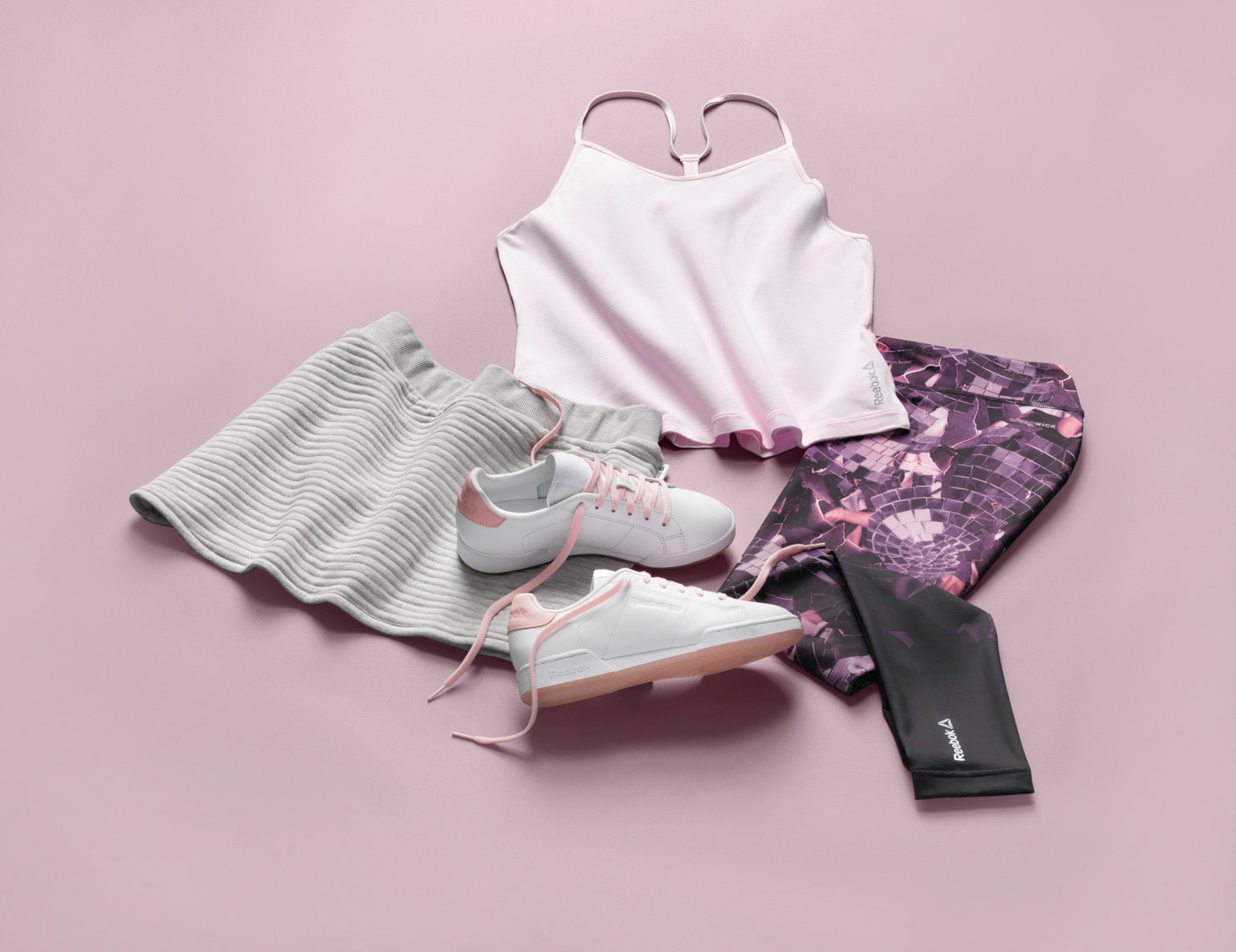 womens workout clothes on a pink background