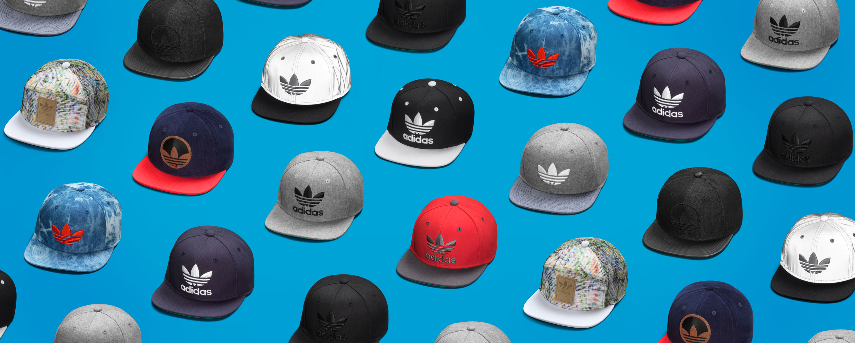 assortment of colorful adidas hats