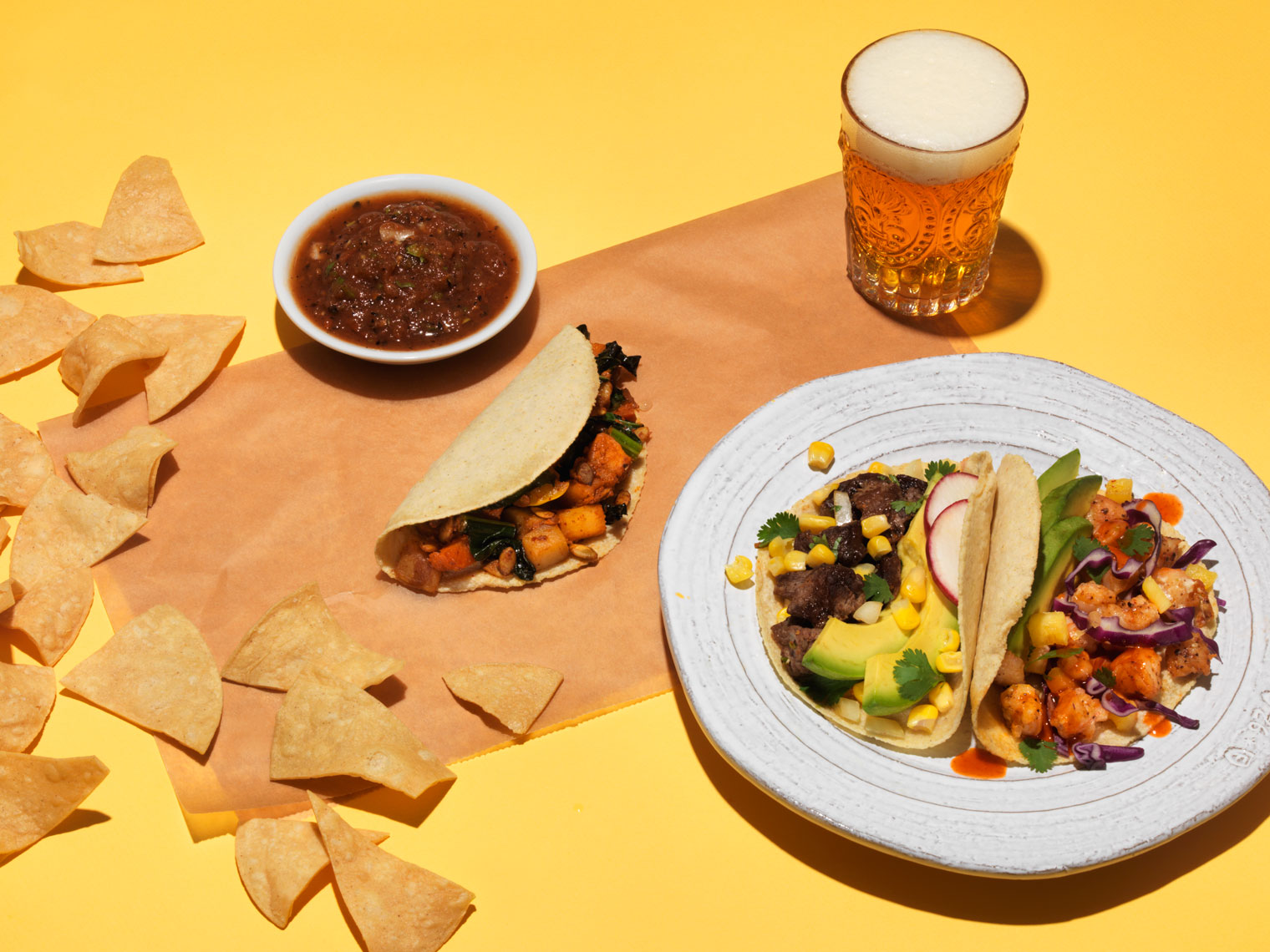 tacos and tortilla chips with a beer mexican food