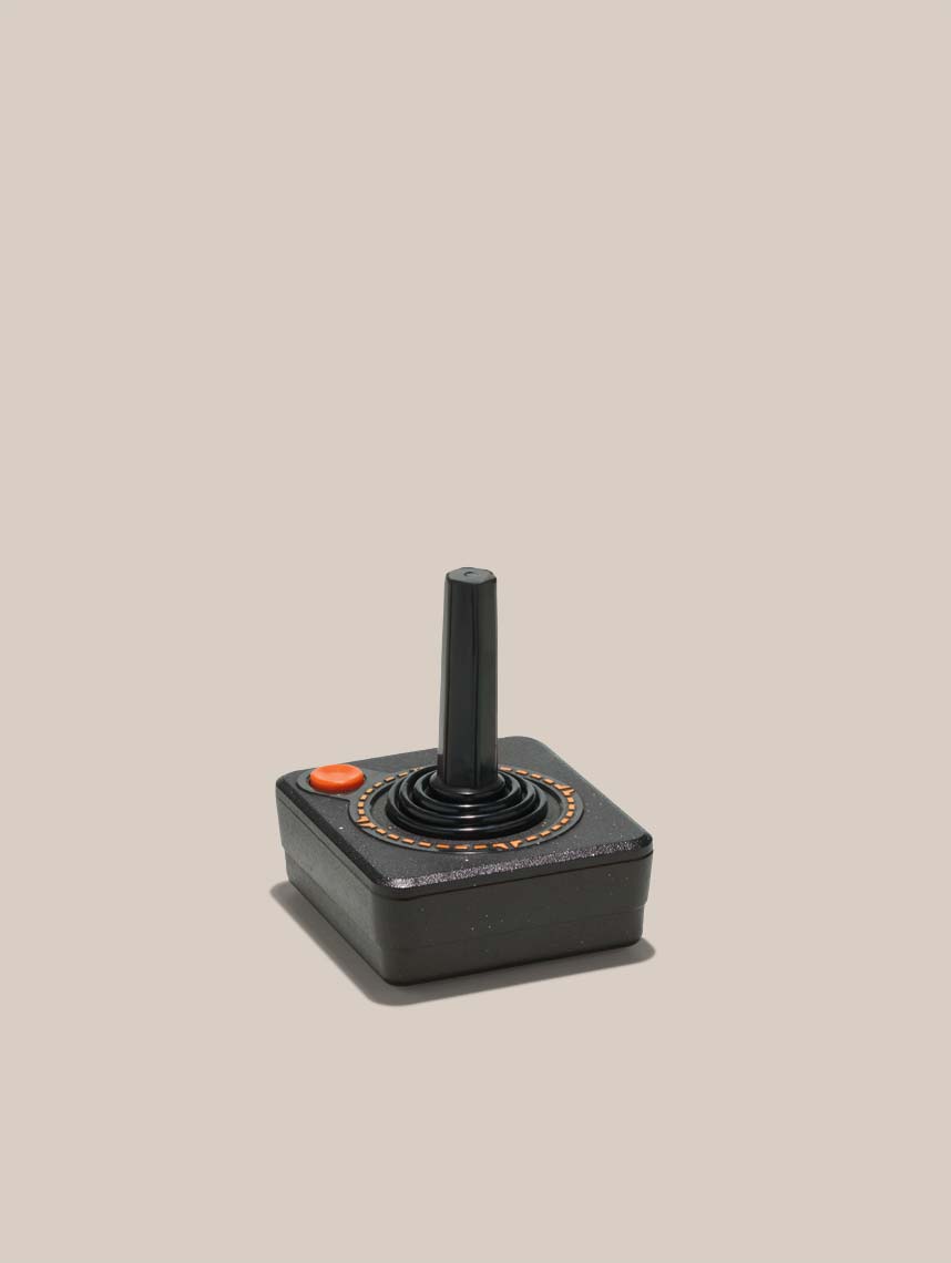 atari joystick on a tan background