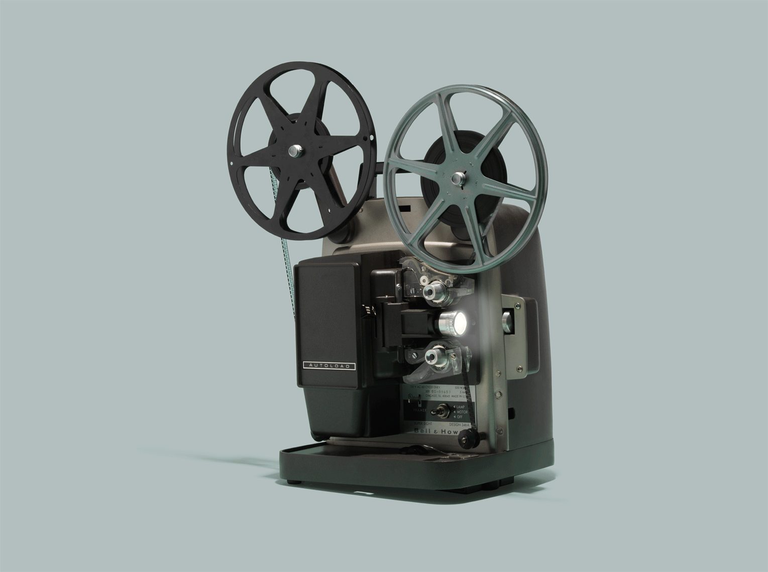 vintage super 8 film projector on a green background 