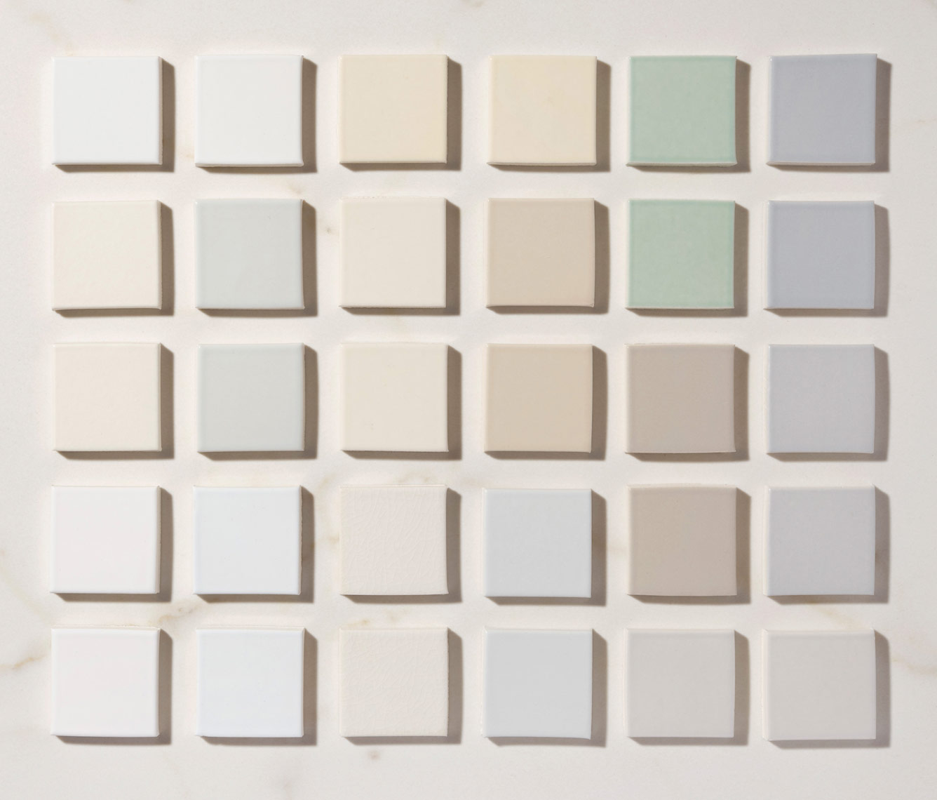 collection of pastel colored ann sacks tiles arranged as a gradient grid