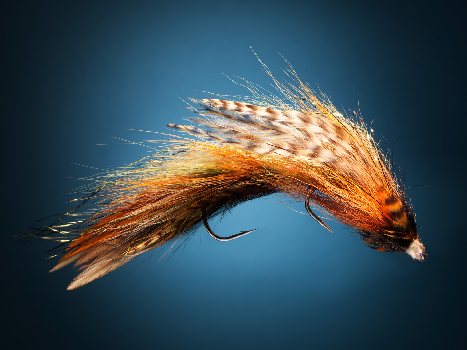 fly fishing jig on a blue background