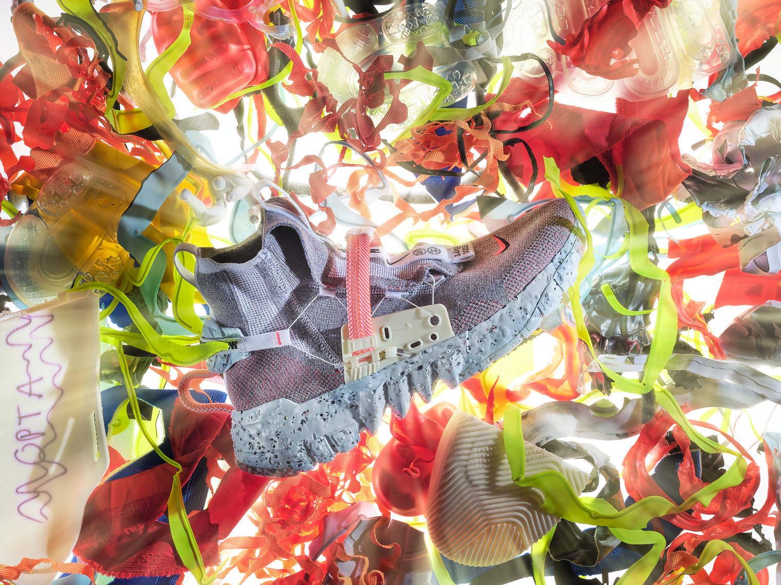 nike space hippie trainer on a bed of flowers with light rays